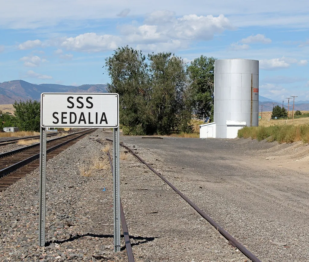 The Santa Fe Railway Water Tank, located along U.S. Route 85 west of its junction with Colorado State Highway 67 in Sedalia, Colorado. The tank is listed on the National Register of Historic Places. A railway sign is on the left.