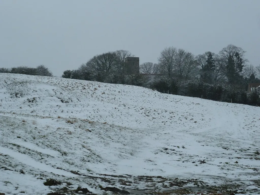View across a snowy field at Pitchcott, Buckinghamshire, to the former parish church of St Giles