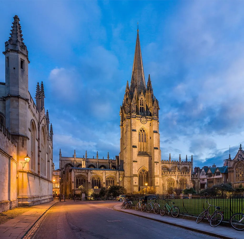 The University Church of St Mary the Virgin viewed from Radcliffe Square. The walls of All Souls College are visible on the left and the chapel of Brasenose College on the far right.