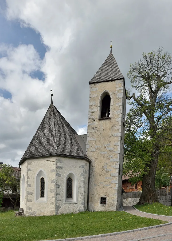 Apsis and leaning steeple of the Saint Lawrence church in Feldthurns in South Tyrol