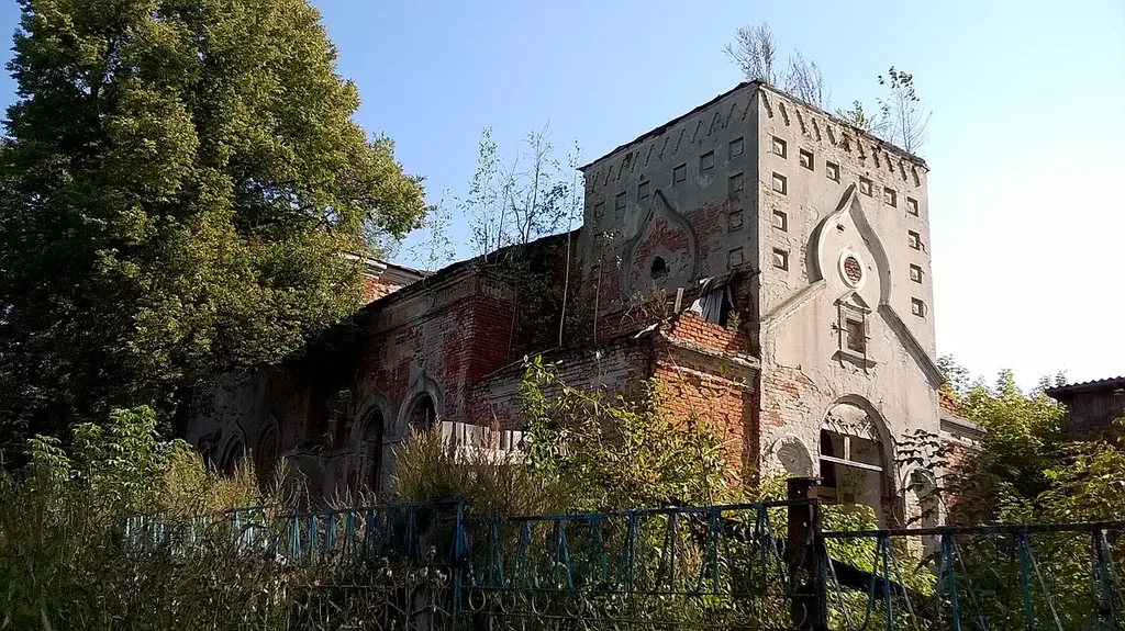 Church of the Kazan Icon of the Mother of God: "near to the printing house", Sukhinichi, Sukhinichi district, Kaluga region. Photo of the northwestern part, from the side where the western gate and bell tower were. The printing house (now inactive) is to the right. Photo taken September 16, 2020