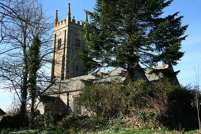 Broadwoodkelly: All Saints Church The church, dedicated to All Saints, has a tower with set-back buttresses. The medieval dedication has been lost. Looking north west