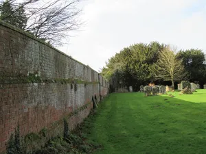 Wall To The South Side Of The Churchyard Of The Church Of St Peter Including 3 Headstones