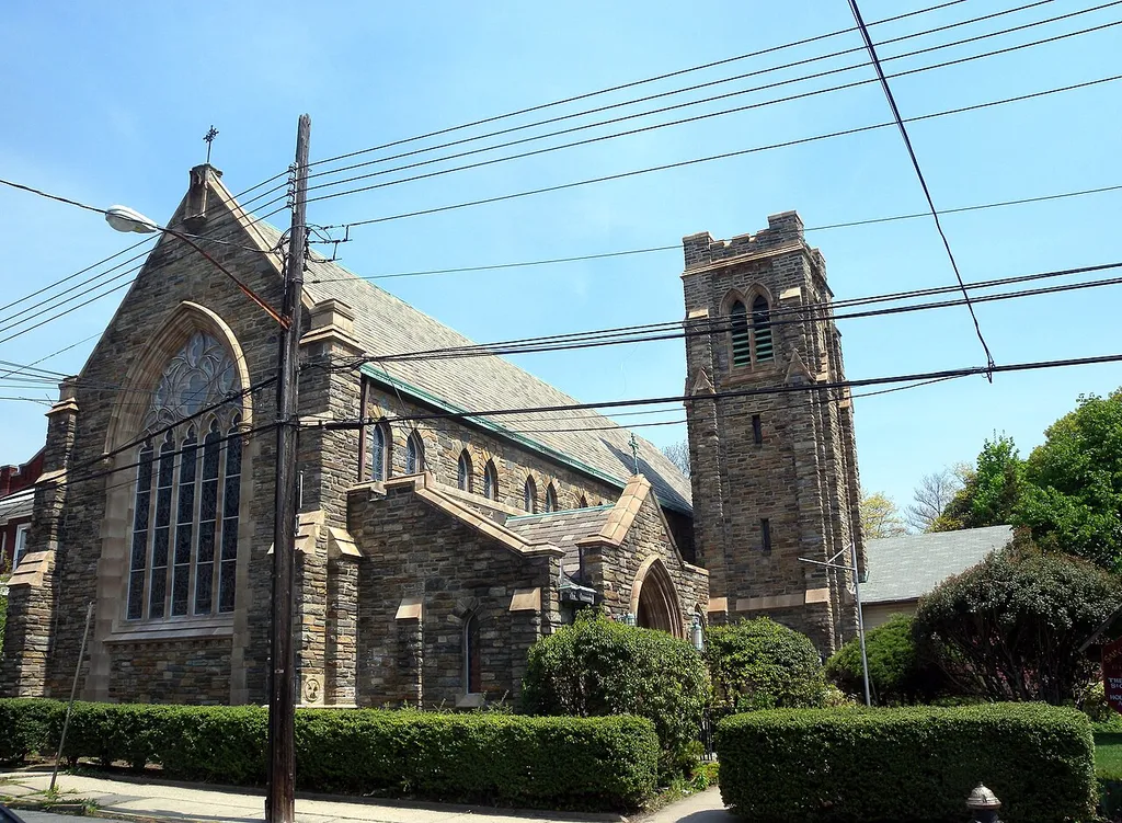 Looking northeast at All Saints Episcopal Church (formery St Matthews's) in Woodhaven, south of the former Brooklyn Manor station, on a sunny midday.